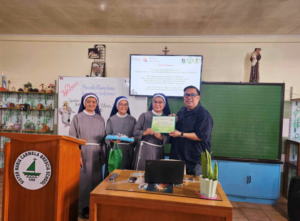 With hearts full of joy, these 3 Franciscan Sisters enthusiastically presented Dr. Terry Arias with a certificate of appreciation.