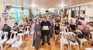 The parents and the 3 Franciscan Sisters joined Dr. Terry Arias for a group photo opportunity.