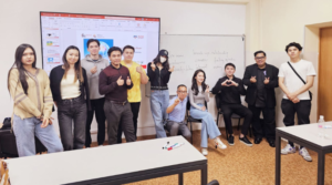 Post-discussion vibrancy shines through at AlmaU School of Management as students and Professor Askarov Dauren share a relaxed moment with Dr. Arias, reflecting a collective sense of relief and gratitude after a meaningful lecture addressing the intricacies of mental health.